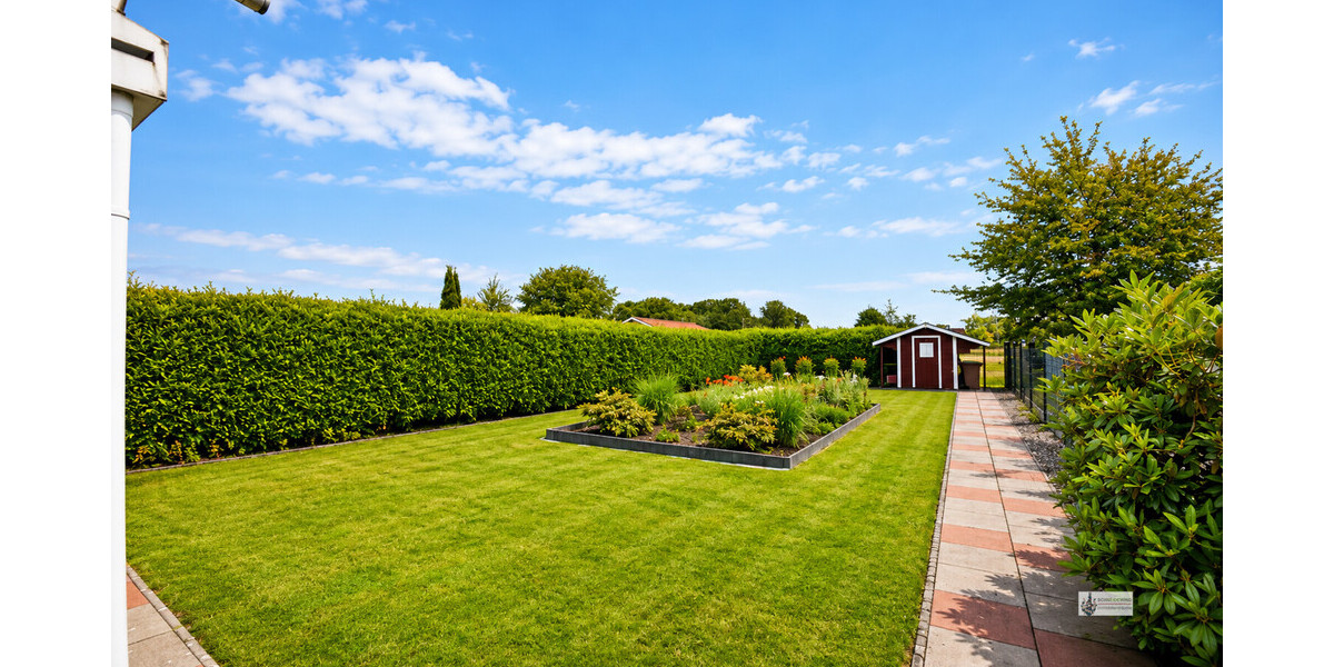 Heller Garten mit blühendem Beet